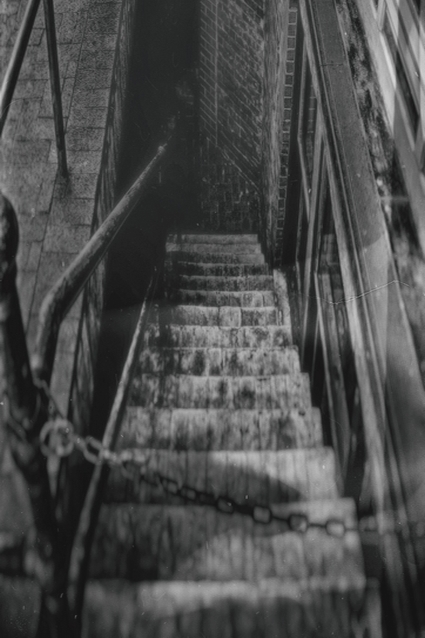 a dark outdoor stairway into the ground