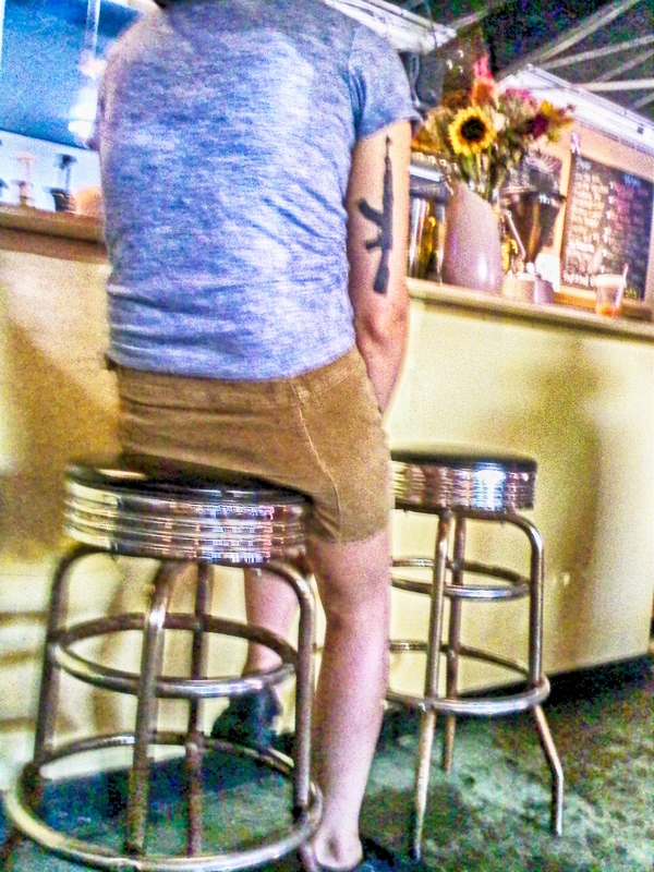 Rifle tattoo on woman